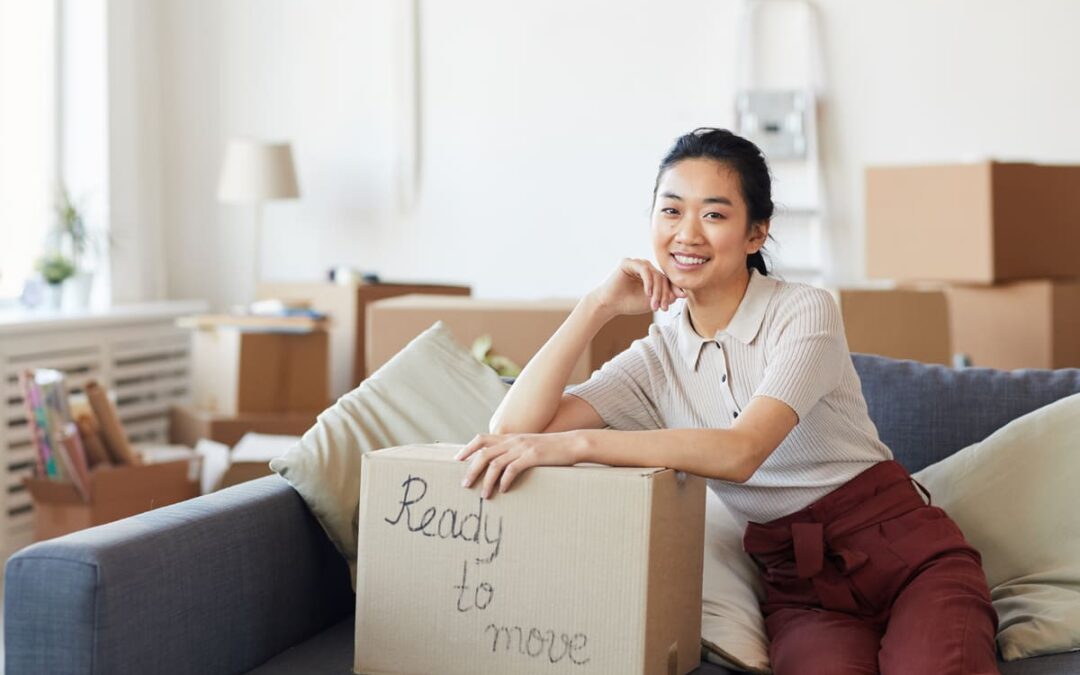 woman sitting on couch with box