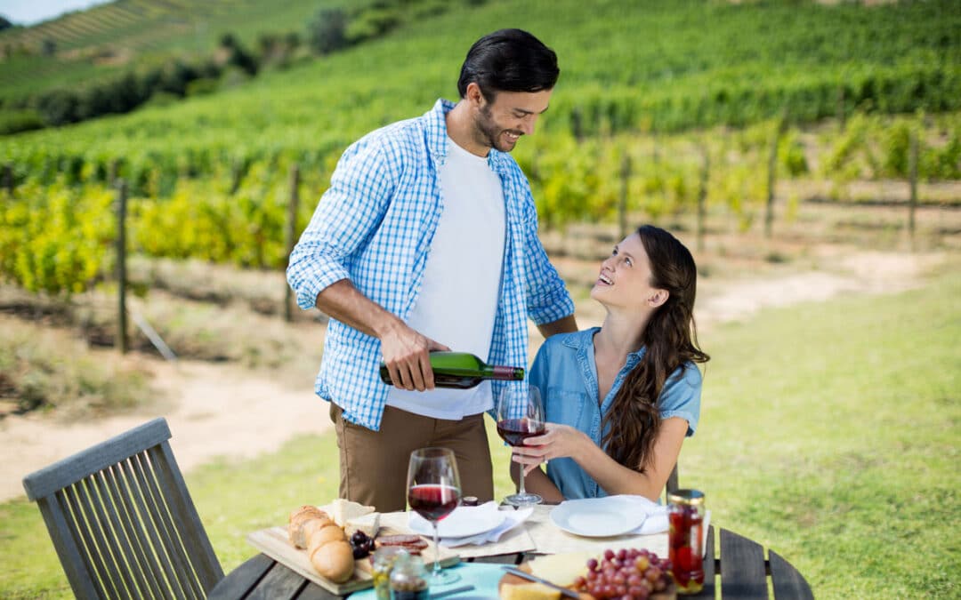 happy couple drinking wine at their new vineyard property